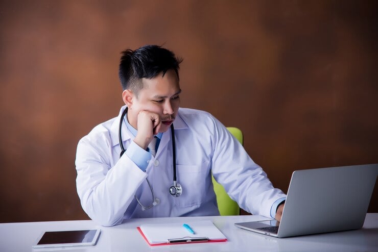 Doctor checking Computer