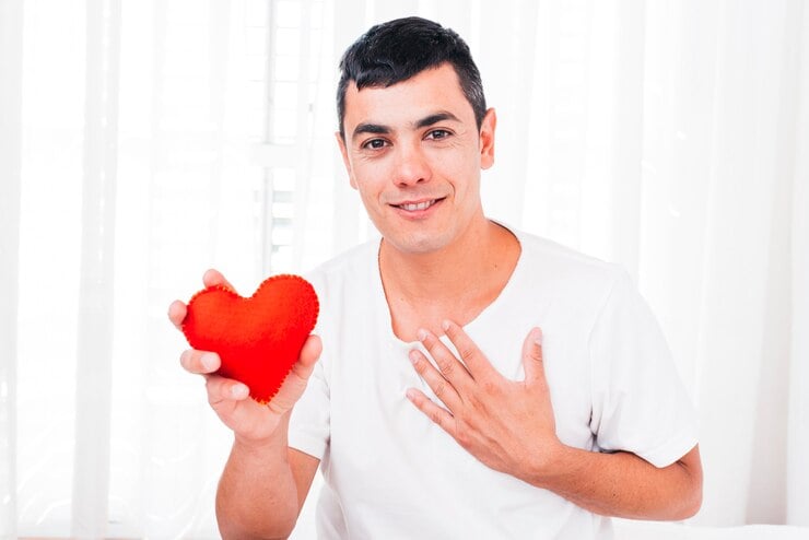 smiling-man-with-hand-chest-holding-
